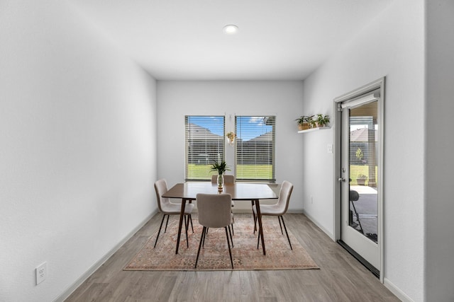 dining space with light hardwood / wood-style flooring