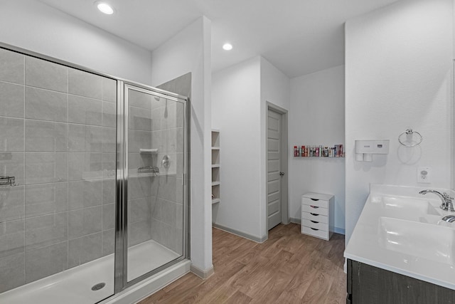 bathroom with vanity, an enclosed shower, and hardwood / wood-style flooring