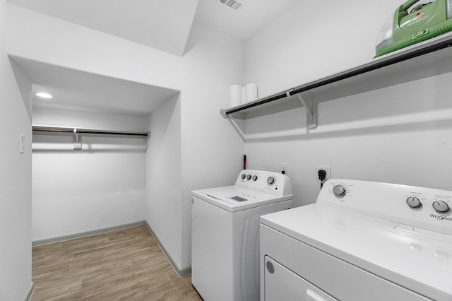 washroom featuring independent washer and dryer and light wood-type flooring