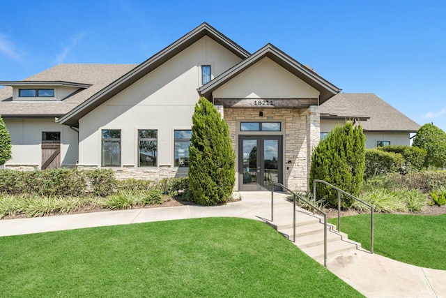 view of front of home featuring a front yard and french doors