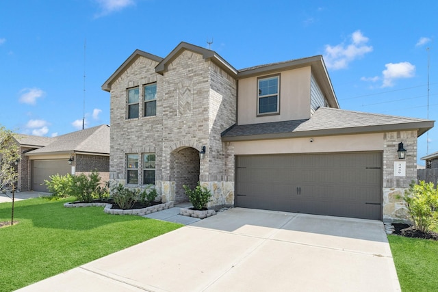 view of front of property with a front lawn and a garage