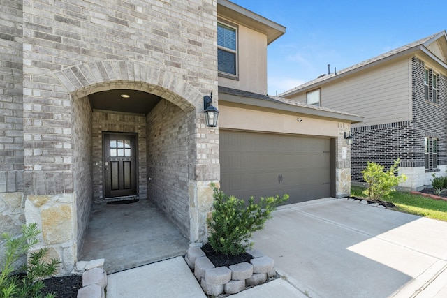 doorway to property with a garage