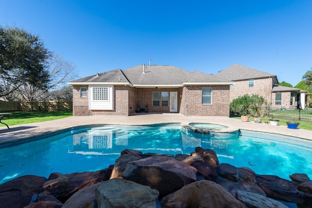 view of swimming pool featuring an in ground hot tub