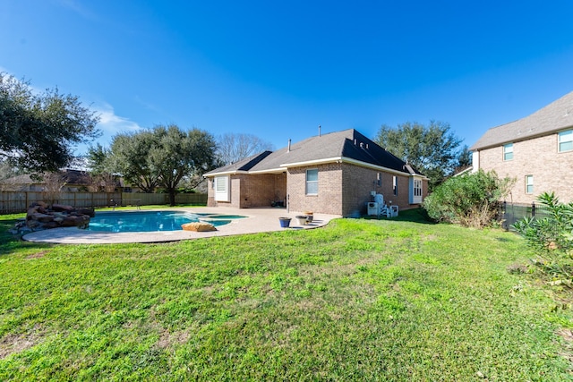 exterior space with a patio, a fenced in pool, and a yard