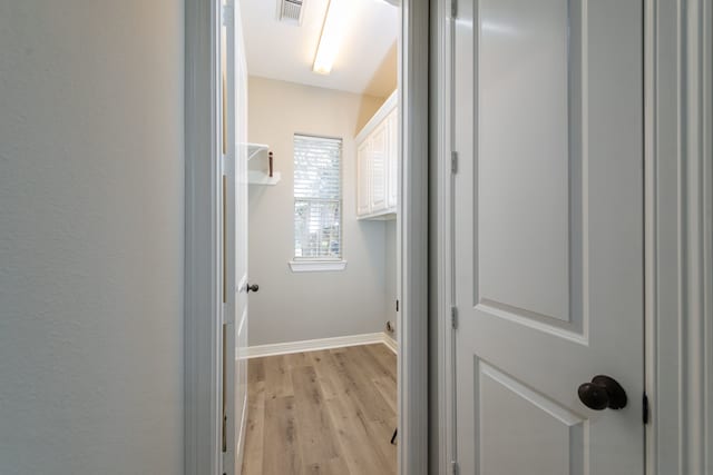 corridor with light hardwood / wood-style flooring