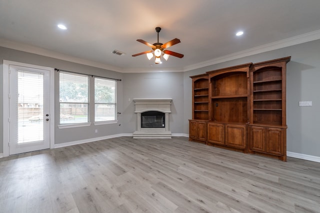 unfurnished living room with ornamental molding, ceiling fan, light hardwood / wood-style floors, and a healthy amount of sunlight