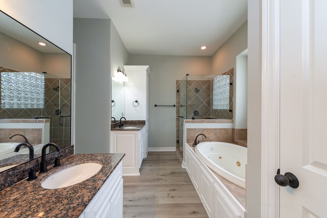 bathroom featuring separate shower and tub, hardwood / wood-style floors, and vanity