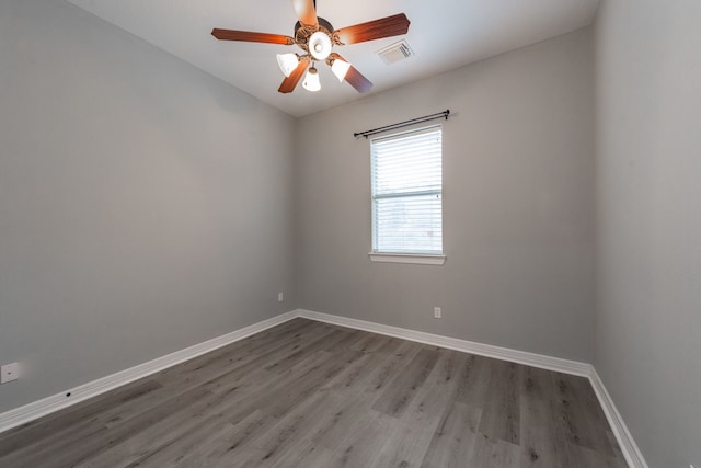 spare room featuring wood-type flooring