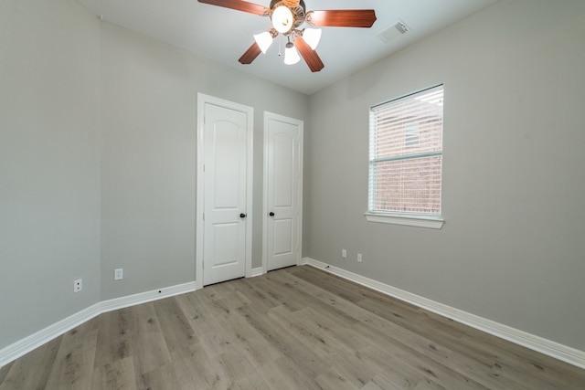 unfurnished bedroom featuring light wood-type flooring and ceiling fan