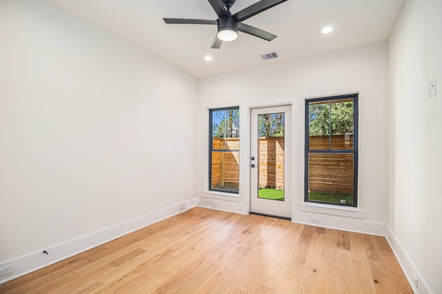 unfurnished room with ceiling fan and light wood-type flooring