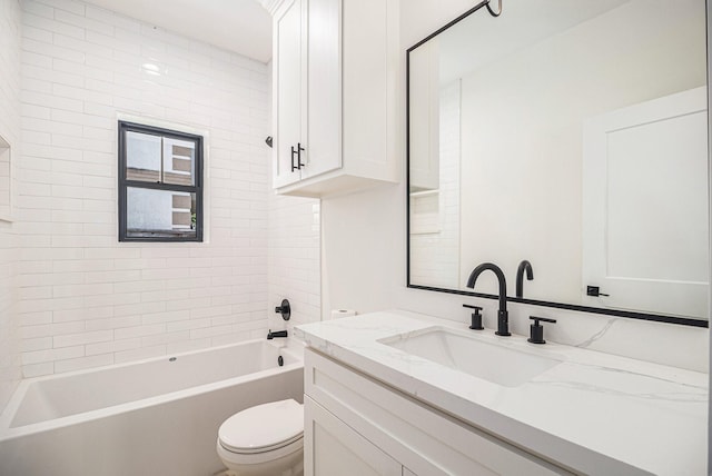 full bathroom featuring tiled shower / bath combo, toilet, and vanity