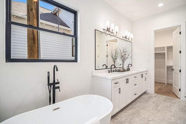 bathroom with vanity and a tub