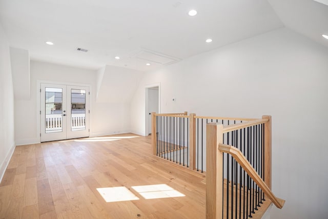 interior space with french doors, light hardwood / wood-style flooring, and lofted ceiling