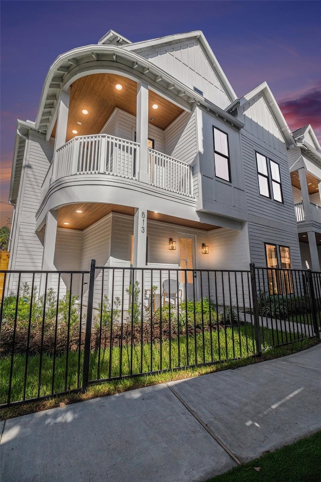 property exterior at dusk with a balcony