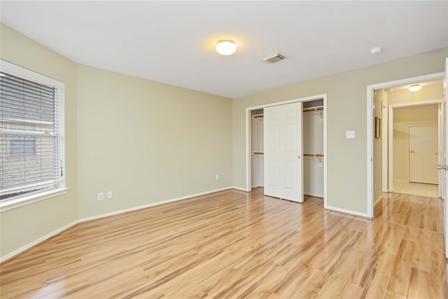 unfurnished bedroom featuring a closet and light hardwood / wood-style floors