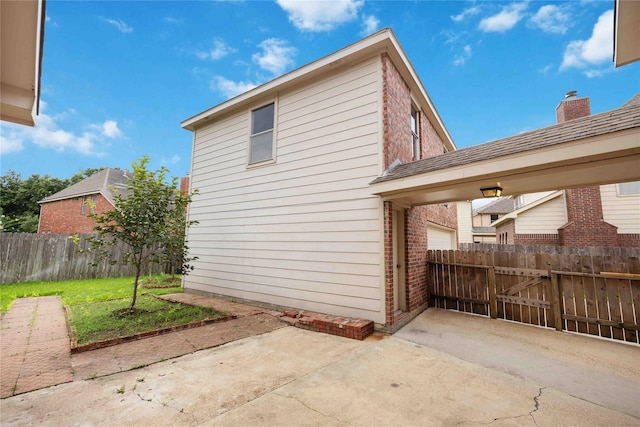 view of property exterior featuring a patio area and a yard