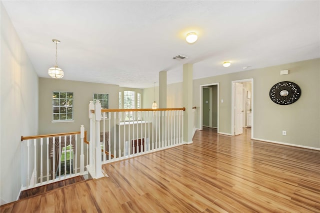 empty room with hardwood / wood-style flooring