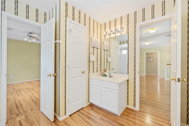 bathroom featuring ceiling fan, vanity, and hardwood / wood-style floors