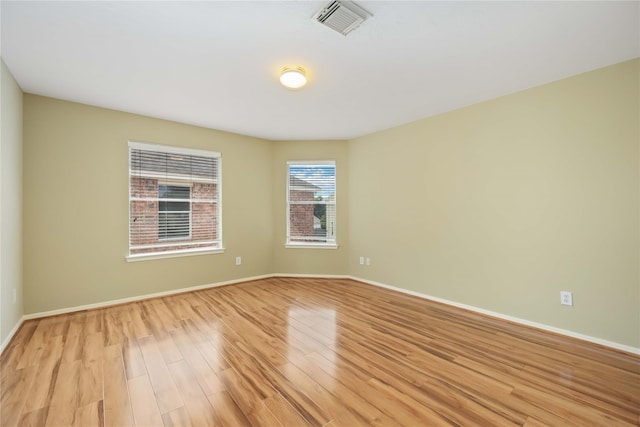 empty room with light hardwood / wood-style flooring