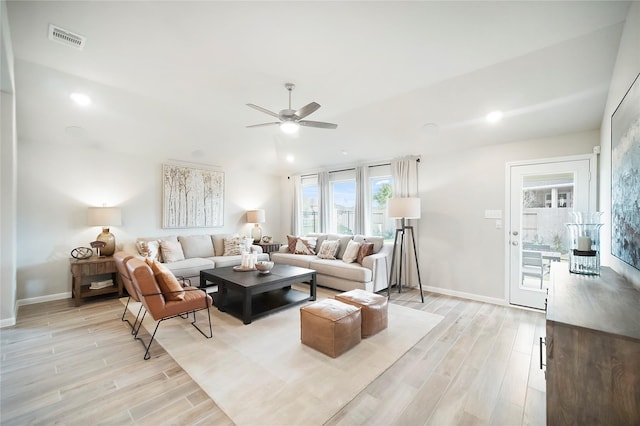 living room with ceiling fan and light hardwood / wood-style flooring