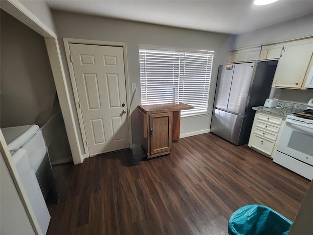 kitchen featuring white electric range oven, dark hardwood / wood-style floors, stainless steel refrigerator, and white cabinets