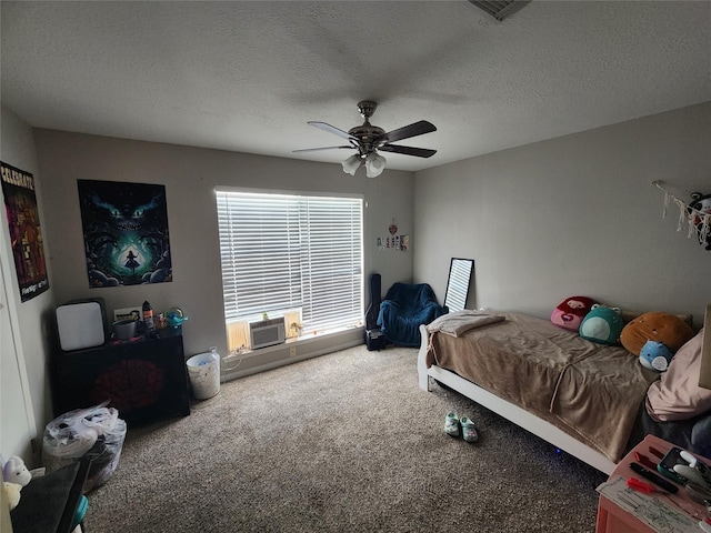 bedroom with a textured ceiling, carpet floors, and ceiling fan