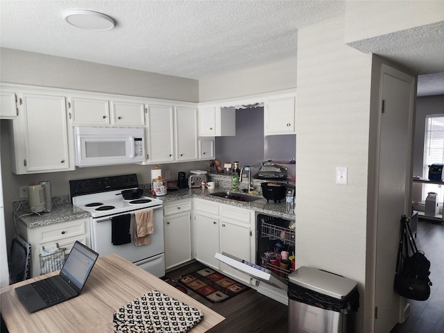 kitchen with light stone countertops, a textured ceiling, white appliances, sink, and white cabinetry