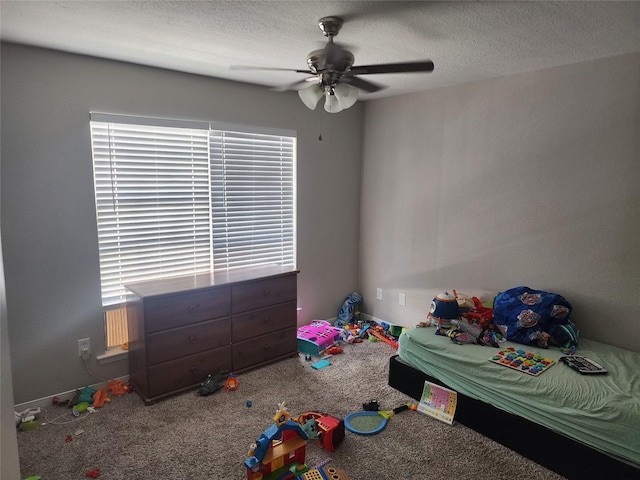 unfurnished bedroom featuring a textured ceiling, carpet floors, and ceiling fan