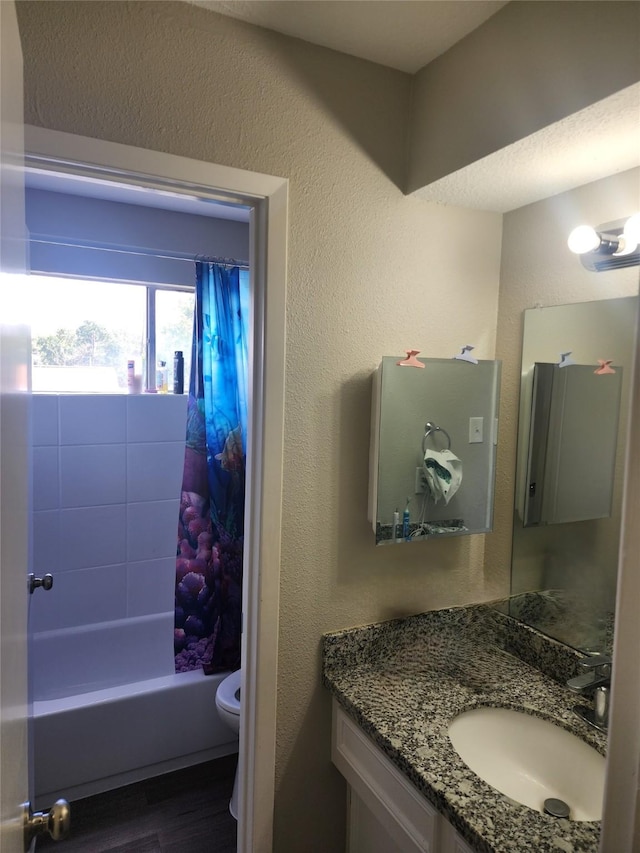 full bathroom featuring hardwood / wood-style flooring, shower / bath combo, toilet, and vanity