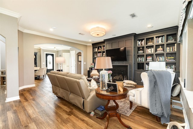 living room with dark wood-type flooring and ornamental molding