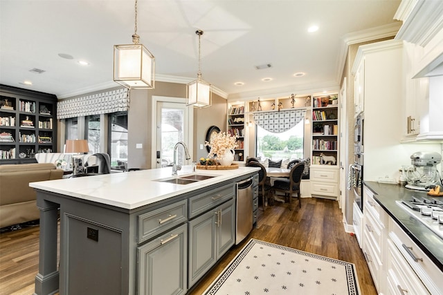 kitchen with gray cabinets, pendant lighting, white cabinetry, an island with sink, and sink