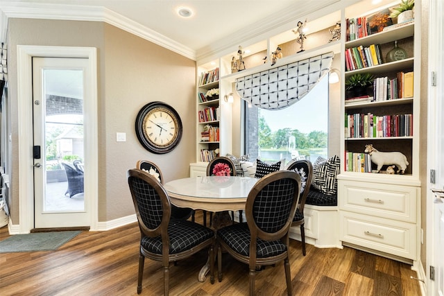 dining room featuring ornamental molding, dark hardwood / wood-style flooring, and built in shelves