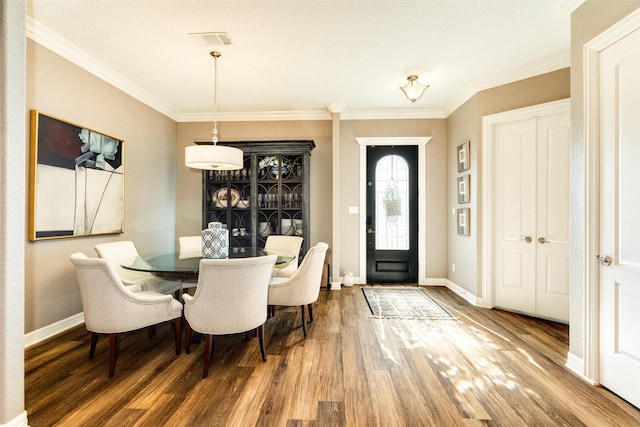 dining room featuring hardwood / wood-style flooring and ornamental molding