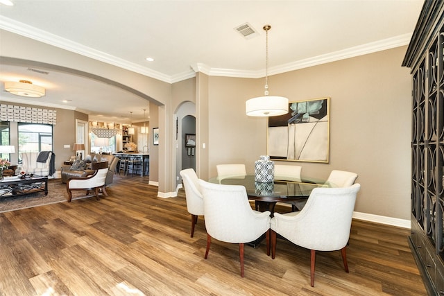 dining area featuring crown molding and wood-type flooring