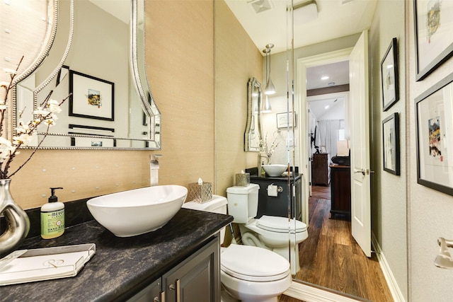 bathroom featuring vanity, hardwood / wood-style floors, and toilet