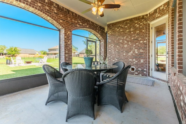 sunroom featuring ceiling fan