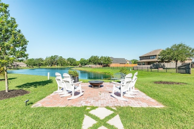 view of yard with a water view, an outdoor fire pit, and a patio