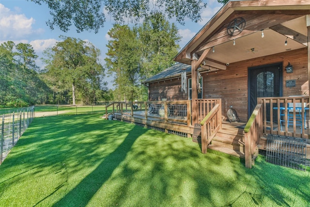 view of yard featuring a wooden deck and french doors