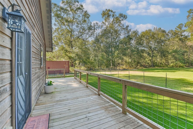 wooden terrace featuring a yard