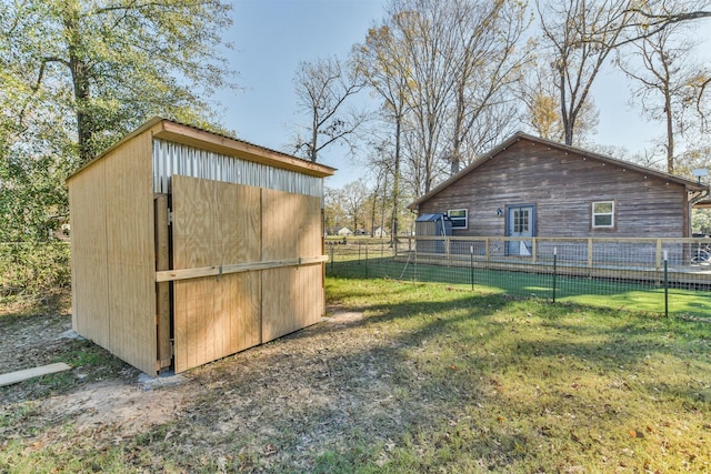 view of outdoor structure featuring a lawn