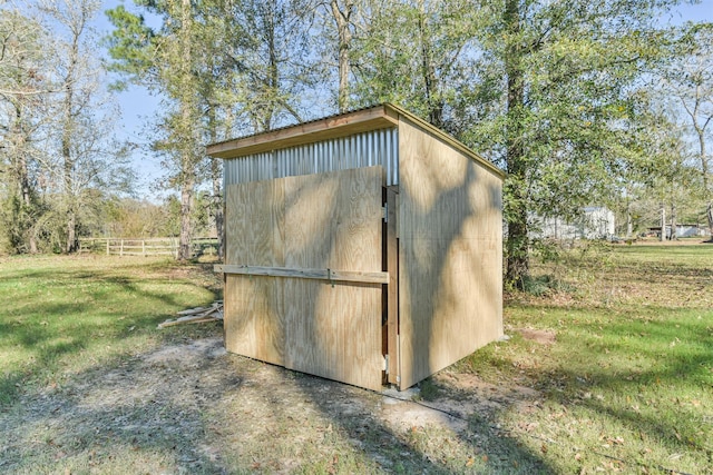 view of outbuilding featuring a yard