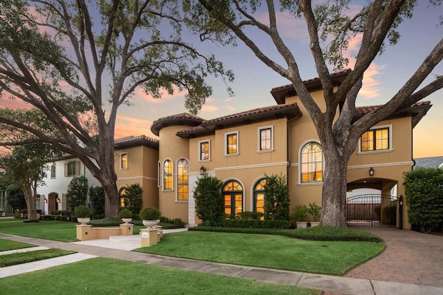 mediterranean / spanish-style house featuring a yard