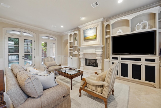 tiled living room with built in features, a fireplace, ornamental molding, and french doors