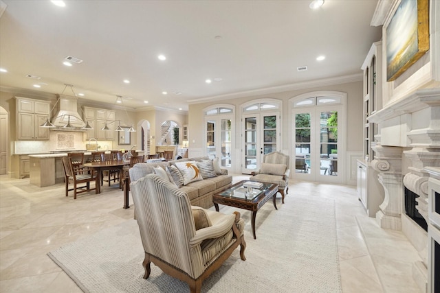 living room with french doors, crown molding, and a premium fireplace