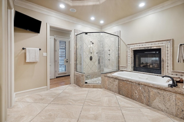 bathroom featuring crown molding, a fireplace, and independent shower and bath
