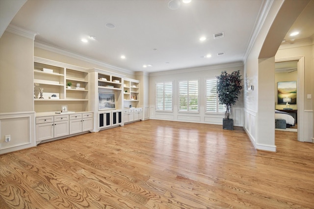 unfurnished living room featuring light hardwood / wood-style floors and ornamental molding