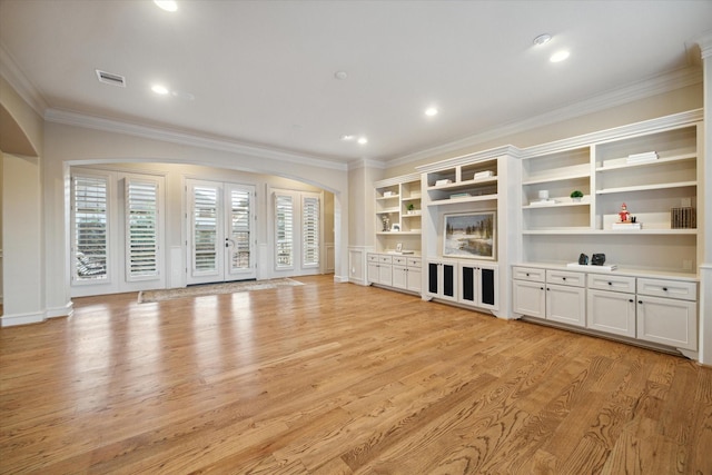 unfurnished living room with light wood-type flooring and ornamental molding