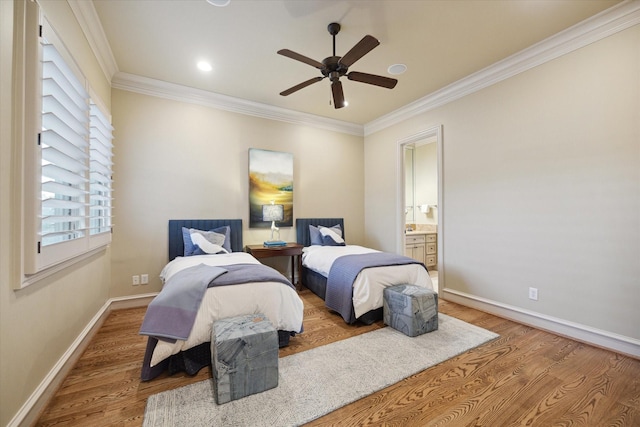 bedroom with hardwood / wood-style floors, ensuite bath, ceiling fan, and ornamental molding