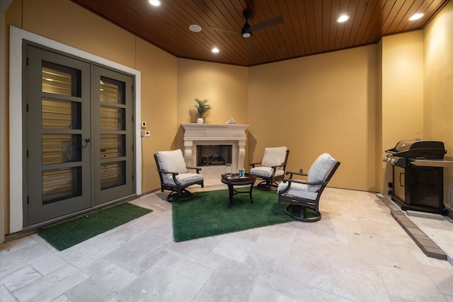 view of patio / terrace featuring french doors, grilling area, ceiling fan, and an outdoor fireplace