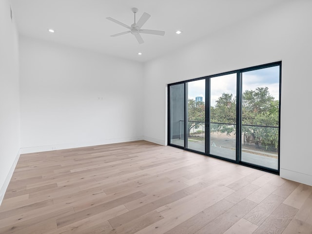 spare room featuring ceiling fan and light hardwood / wood-style flooring